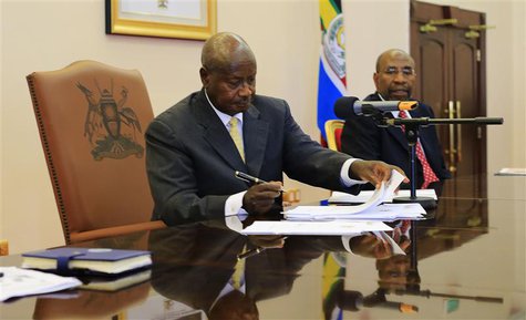 Uganda President Yoweri Museveni signs an anti-homosexual bill into law at the state house in Entebbe, 36 km (22 miles) south west of capita Uganda President Yoweri Museveni signs an anti-homosexual bill into law at the state house in Entebbe, 36 km (22 miles) south west of capita