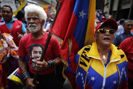 An elderly protester carries a Venezuela's flag during a march for peace in downtown Caracas February 23, 2014. REUTERS/Tomas Bravo An elderly protester carries a Venezuela's flag during a march for peace in downtown Caracas February 23, 2014. REUTERS/Tomas Bravo