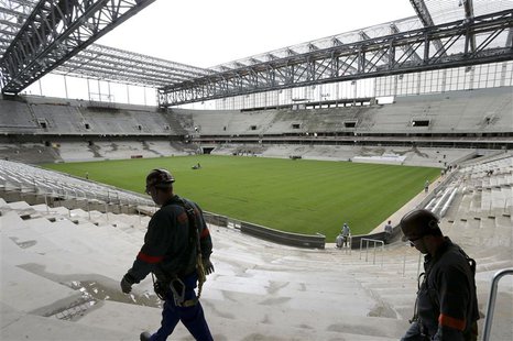 Workers walk inside the Arena da Baixada soccer stadium as it is being built to host matches of the 2014 World Cup in Curitiba, February 17, Workers walk inside the Arena da Baixada soccer stadium as it is being built to host matches of the 2014 World Cup in Curitiba, February 17,