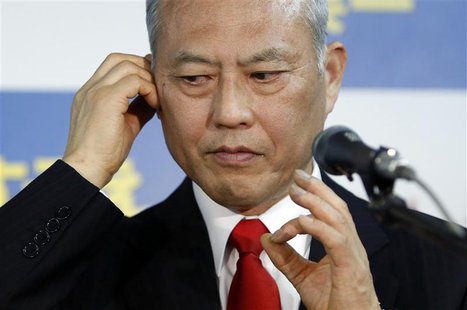 Japan's former health minister Yoichi Masuzoe checks his earphone as he prepares for an interview at his office in Tokyo February 9, 2014. R Japan's former health minister Yoichi Masuzoe checks his earphone as he prepares for an interview at his office in Tokyo February 9, 2014. R