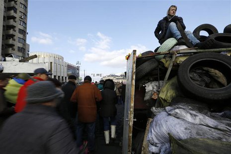 An anti-Yanukovich protester sits atop a barricade in Kiev's Independent Square February 24, 2014. REUTERS/Yannis Behrakis An anti-Yanukovich protester sits atop a barricade in Kiev's Independent Square February 24, 2014. REUTERS/Yannis Behrakis