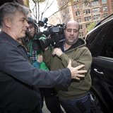 Actor Alec Baldwin directs a TV photographer out of his way in front of his apartment building in New York November 15, 2013. REUTERS/Carlo Actor Alec Baldwin directs a TV photographer out of his way in front of his apartment building in New York November 15, 2013. REUTERS/Carlo