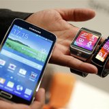 New Samsung Galaxy S5 smartphone (L), Gear 2 smartwatch (C) and Gear Fit fitness band are displayed at the Mobile World Congress in Barcelon New Samsung Galaxy S5 smartphone (L), Gear 2 smartwatch (C) and Gear Fit fitness band are displayed at the Mobile World Congress in Barcelon