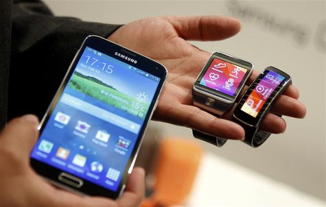 New Samsung Galaxy S5 smartphone (L), Gear 2 smartwatch (C) and Gear Fit fitness band are displayed at the Mobile World Congress in Barcelon New Samsung Galaxy S5 smartphone (L), Gear 2 smartwatch (C) and Gear Fit fitness band are displayed at the Mobile World Congress in Barcelon