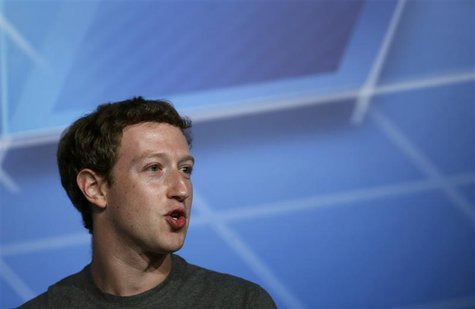 Facebook Chief Executive Officer Mark Zuckerberg smiles on the stage before delivering a keynote speech during the Mobile World Congress in Facebook Chief Executive Officer Mark Zuckerberg smiles on the stage before delivering a keynote speech during the Mobile World Congress in
