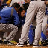 New York Mets catcher Josh Thole is helped to his feet after a collision at home plate with the Philadelphia Phillies Ty Wigginton (unseen) New York Mets catcher Josh Thole is helped to his feet after a collision at home plate with the Philadelphia Phillies Ty Wigginton (unseen)