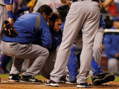 New York Mets catcher Josh Thole is helped to his feet after a collision at home plate with the Philadelphia Phillies Ty Wigginton (unseen) New York Mets catcher Josh Thole is helped to his feet after a collision at home plate with the Philadelphia Phillies Ty Wigginton (unseen)