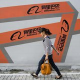 A woman walks past an Alibaba advertisement on a wall in Hangzhou, Zhejiang province September 26, 2013. REUTERS/Chance Chan A woman walks past an Alibaba advertisement on a wall in Hangzhou, Zhejiang province September 26, 2013. REUTERS/Chance Chan