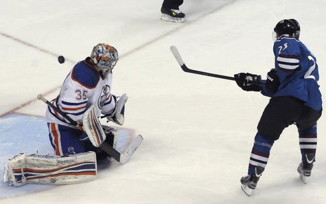 Colorado Avalanche's Milan Hejduk (R) scores the first goal in the shoot out against Edmonton Oilers' Semyon Varlamov (L) during their NHL h Colorado Avalanche's Milan Hejduk (R) scores the first goal in the shoot out against Edmonton Oilers' Semyon Varlamov (L) during their NHL h