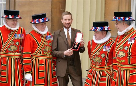 British cyclist Bradley Wiggins poses for a photograph with his Knighthood medal, and Yeomen of the Guard, awarded to him by Queen Elizabeth British cyclist Bradley Wiggins poses for a photograph with his Knighthood medal, and Yeomen of the Guard, awarded to him by Queen Elizabeth