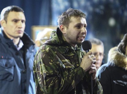 Anti-presidential protester Volodymyr Parasiuk addresses the crowd as opposition leader Vitaly Klitschko (L) looks on during a rally in Kiev Anti-presidential protester Volodymyr Parasiuk addresses the crowd as opposition leader Vitaly Klitschko (L) looks on during a rally in Kiev