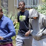 South African "Blade Runner" Oscar Pistorius (R) is escorted by police at a Pretoria police station February 14, 2013. REUTERS/Stringer South African "Blade Runner" Oscar Pistorius (R) is escorted by police at a Pretoria police station February 14, 2013. REUTERS/Stringer