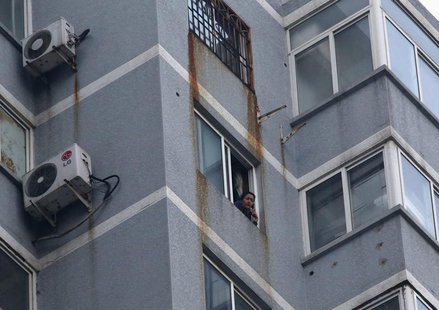 Guzailai Nu'er, the wife of Ilham Tohti, speaks as she has an interview with Reuters by a phone from window of her house in Beijing, January Guzailai Nu'er, the wife of Ilham Tohti, speaks as she has an interview with Reuters by a phone from window of her house in Beijing, January