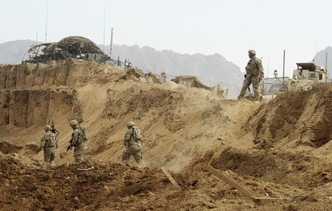 U.S. troops investigate the site of a suicide attack on a NATO base in Zhari, west of Kandahar province, January 20, 2014. REUTERS/Ahmad Nad U.S. troops investigate the site of a suicide attack on a NATO base in Zhari, west of Kandahar province, January 20, 2014. REUTERS/Ahmad Nad