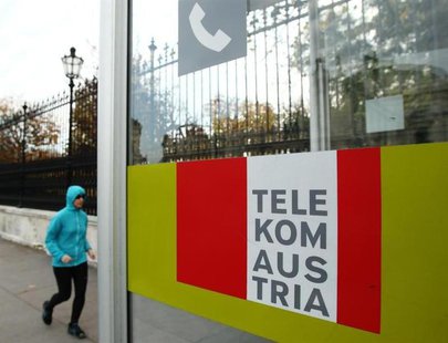 A jogger runs by a Telekom Austria phone booth in Vienna November 14, 2013. REUTERS/Heinz-Peter Bader A jogger runs by a Telekom Austria phone booth in Vienna November 14, 2013. REUTERS/Heinz-Peter Bader