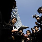 A Japanese investor (C) speaks to the media as he protests against Mt. Gox, in front of the building where the digital marketplace operator A Japanese investor (C) speaks to the media as he protests against Mt. Gox, in front of the building where the digital marketplace operator
