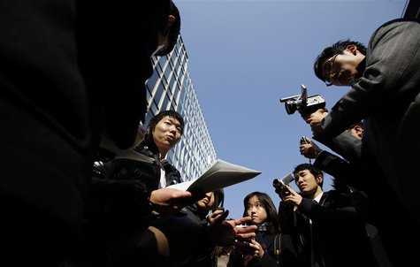 A Japanese investor (C) speaks to the media as he protests against Mt. Gox, in front of the building where the digital marketplace operator A Japanese investor (C) speaks to the media as he protests against Mt. Gox, in front of the building where the digital marketplace operator