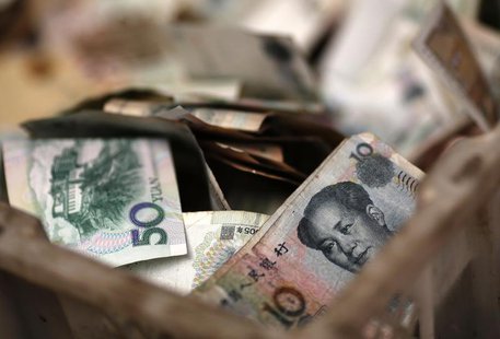 Chinese banknotes are seen at a vendor's cash box at a market in Beijing February 14, 2014. REUTERS/Kim Kyung-Hoon Chinese banknotes are seen at a vendor's cash box at a market in Beijing February 14, 2014. REUTERS/Kim Kyung-Hoon