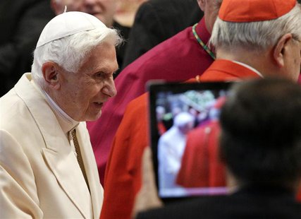 A faithful takes a picture as former pope Benedict XVI arrives for a consistory ceremony led by Pope Francis in Saint Peter's Basilica at th A faithful takes a picture as former pope Benedict XVI arrives for a consistory ceremony led by Pope Francis in Saint Peter's Basilica at th