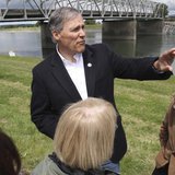 Washington State Governor Jay Inslee looks over the scene as a span of highway bridge sits in the Skagit River May 24, 2013 after collapsing Washington State Governor Jay Inslee looks over the scene as a span of highway bridge sits in the Skagit River May 24, 2013 after collapsing