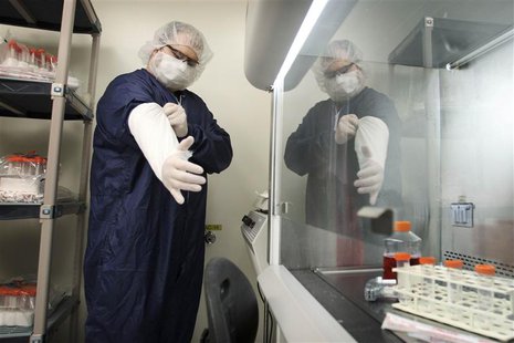 Derek Grice pulls additional sterilized covers on his arms in a Northwest Biotherapeutics laboratory in Memphis, Tennessee, February 21, 201 Derek Grice pulls additional sterilized covers on his arms in a Northwest Biotherapeutics laboratory in Memphis, Tennessee, February 21, 201