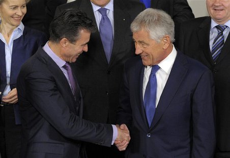 U.S. Secretary of Defense Chuck Hagel (R) shakes hands with NATO Secretary-General Anders Fogh Rasmussen during a NATO defence ministers' me U.S. Secretary of Defense Chuck Hagel (R) shakes hands with NATO Secretary-General Anders Fogh Rasmussen during a NATO defence ministers' me