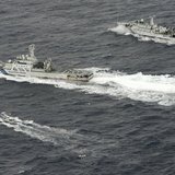 An aerial photo shows Chinese marine surveillance ship Haijian No. 66 (top) trying to approach a Japanese fishing boat (bottom) as Japan Coa An aerial photo shows Chinese marine surveillance ship Haijian No. 66 (top) trying to approach a Japanese fishing boat (bottom) as Japan Coa