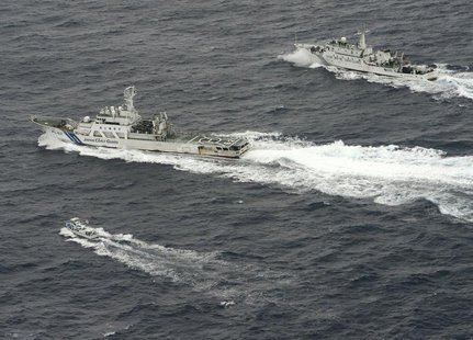 An aerial photo shows Chinese marine surveillance ship Haijian No. 66 (top) trying to approach a Japanese fishing boat (bottom) as Japan Coa An aerial photo shows Chinese marine surveillance ship Haijian No. 66 (top) trying to approach a Japanese fishing boat (bottom) as Japan Coa