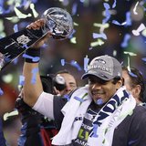 Seattle Seahawks quarterback Russell Wilson holds up the Vince Lombardi Trophy after the Seahawks defeated the Denver Broncos in the NFL Sup Seattle Seahawks quarterback Russell Wilson holds up the Vince Lombardi Trophy after the Seahawks defeated the Denver Broncos in the NFL Sup