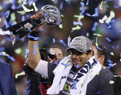 Seattle Seahawks quarterback Russell Wilson holds up the Vince Lombardi Trophy after the Seahawks defeated the Denver Broncos in the NFL Sup Seattle Seahawks quarterback Russell Wilson holds up the Vince Lombardi Trophy after the Seahawks defeated the Denver Broncos in the NFL Sup