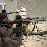 Masked Sunni Muslims gunmen take position with their weapons during their patrol in the city of Falluja, 70 km (43 miles) west of Baghdad, F Masked Sunni Muslims gunmen take position with their weapons during their patrol in the city of Falluja, 70 km (43 miles) west of Baghdad, F
