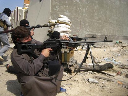 Masked Sunni Muslims gunmen take position with their weapons during their patrol in the city of Falluja, 70 km (43 miles) west of Baghdad, F Masked Sunni Muslims gunmen take position with their weapons during their patrol in the city of Falluja, 70 km (43 miles) west of Baghdad, F