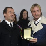 Russia's Prime Minister Dmitry Medvedev and figure skating gold medal winner Evgeni Plushenko (R) attend a ceremony to present automobiles t Russia's Prime Minister Dmitry Medvedev and figure skating gold medal winner Evgeni Plushenko (R) attend a ceremony to present automobiles t