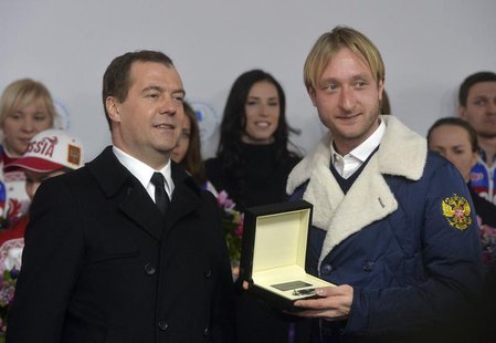 Russia's Prime Minister Dmitry Medvedev and figure skating gold medal winner Evgeni Plushenko (R) attend a ceremony to present automobiles t Russia's Prime Minister Dmitry Medvedev and figure skating gold medal winner Evgeni Plushenko (R) attend a ceremony to present automobiles t