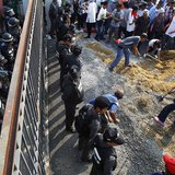 Government supporters begin to build a wall at the gates of the National Anti-Corruption Commission (NACC) office as policemen guard it in N Government supporters begin to build a wall at the gates of the National Anti-Corruption Commission (NACC) office as policemen guard it in N