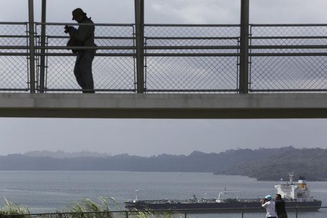 Visitor is seen as a cargo boat waits to enter the panama canal next to a construction site of the Expansion project (not pictured) on the o Visitor is seen as a cargo boat waits to enter the panama canal next to a construction site of the Expansion project (not pictured) on the o