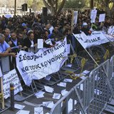 Demonstrators hold signs and banners outside Cyprus’s parliament as they protest plans by the government to sell off state-owned enterprises Demonstrators hold signs and banners outside Cyprus’s parliament as they protest plans by the government to sell off state-owned enterprises