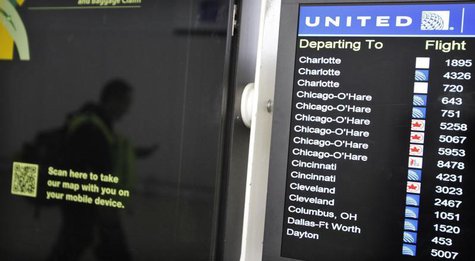A customer is reflected in a screen showing the schedule times of United at Newark International airport in New Jersey , November 15, 2012. A customer is reflected in a screen showing the schedule times of United at Newark International airport in New Jersey , November 15, 2012.