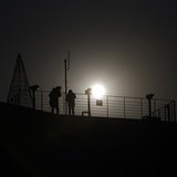 A visitor (L) looks towards the north through a pair of binoculars near the demilitarized zone separating the two Koreas, in Paju, 55 km (34 A visitor (L) looks towards the north through a pair of binoculars near the demilitarized zone separating the two Koreas, in Paju, 55 km (34