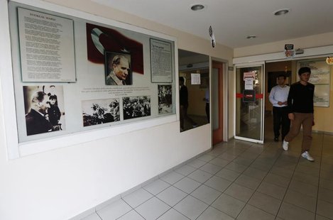 Students walk past photographs of modern Turkey's secular founder Mustafa Kemal Ataturk hanging on a wall at the entrance of FEM University Students walk past photographs of modern Turkey's secular founder Mustafa Kemal Ataturk hanging on a wall at the entrance of FEM University
