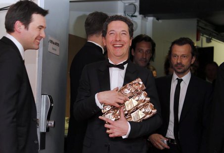 French actor Guillaume Gallienne (C) holds his trophy during a photocall after receiving the Best Actor, Best first Film, Best adaptated Scr French actor Guillaume Gallienne (C) holds his trophy during a photocall after receiving the Best Actor, Best first Film, Best adaptated Scr