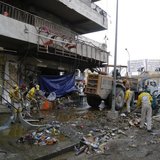 Municipal workers clean up the site of a car bomb attack in Baghdad's Karaada district February 26, 2014. REUTERS/Thaier al-Sudani Municipal workers clean up the site of a car bomb attack in Baghdad's Karaada district February 26, 2014. REUTERS/Thaier al-Sudani