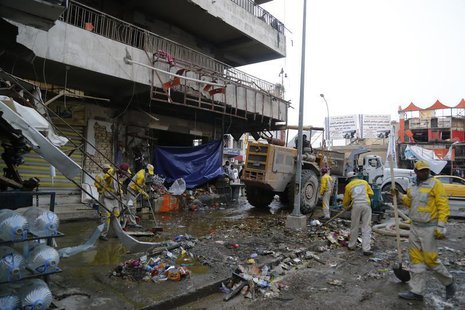 Municipal workers clean up the site of a car bomb attack in Baghdad's Karaada district February 26, 2014. REUTERS/Thaier al-Sudani Municipal workers clean up the site of a car bomb attack in Baghdad's Karaada district February 26, 2014. REUTERS/Thaier al-Sudani