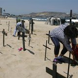 Anti-government protesters place crucifixes with names of victims of violence as a form of protest at the beach in Puerto La Cruz March 1, 2 Anti-government protesters place crucifixes with names of victims of violence as a form of protest at the beach in Puerto La Cruz March 1, 2