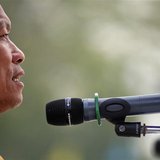 Buddhist monk and anti-government protest leader Luang Pu Buddha Issara addresses his supporters from the stage at a protest site north of B Buddhist monk and anti-government protest leader Luang Pu Buddha Issara addresses his supporters from the stage at a protest site north of B