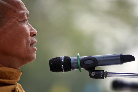 Buddhist monk and anti-government protest leader Luang Pu Buddha Issara addresses his supporters from the stage at a protest site north of B Buddhist monk and anti-government protest leader Luang Pu Buddha Issara addresses his supporters from the stage at a protest site north of B