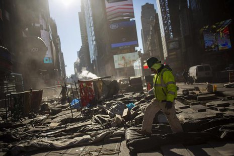 A worker walks while repairing the road at Times Square in New York December 13, 2013. REUTERS/Eric Thayer A worker walks while repairing the road at Times Square in New York December 13, 2013. REUTERS/Eric Thayer
