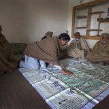 Local elders point to their fruit orchards on a map showing lands, taken over by the army for a base, in the town of Khwazakhela in the nort Local elders point to their fruit orchards on a map showing lands, taken over by the army for a base, in the town of Khwazakhela in the nort