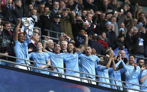 Manchester City captain Vincent Kompany holds aloft the trophy after defeating Sunderland to win the English League Cup final soccer match a Manchester City captain Vincent Kompany holds aloft the trophy after defeating Sunderland to win the English League Cup final soccer match a