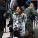 An environmental activist sings and cheers as she and others are detained as they hold a rally in opposition to the Keystone XL Pipeline on An environmental activist sings and cheers as she and others are detained as they hold a rally in opposition to the Keystone XL Pipeline on